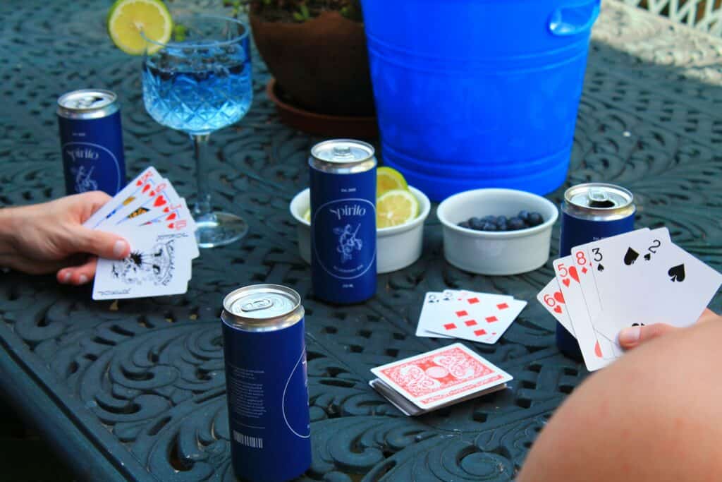 Friends sitting at table playing drinking games
