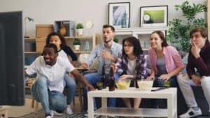friends watching tv playing and learning the friends drinking game rules.